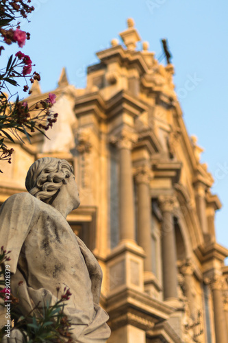 statue in front of cathedral facade in catania italy