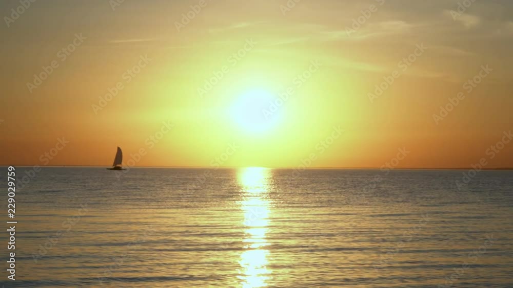 Amazing colors of tropical sunset. Sail boats silhouettes floating on ocean horizon. Amazing colors of tropical sunset. Sail boats silhouettes floating on ocean horizon.