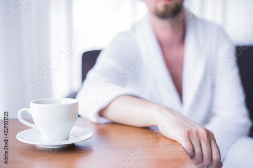 Sad man sitting near a window