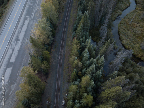 Aerial drone shot of Canadian country side with road, rail and creek 