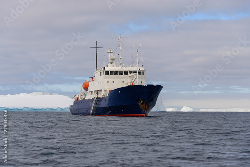 Expedition ship with iceberg in Antarctic sea