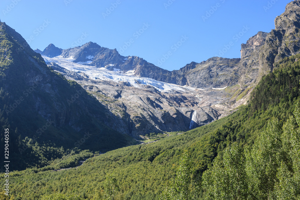 Closeup view mountains scenes in national park Dombai, Caucasus, Russia, Europe. Summer landscape, sunshine weather, dramatic blue sky and sunny day Closeup view mountains scenes in national park Dombai, Caucasus, Russia, Europe. Summer landscape, sunshine weather, dramatic blue sky and sunny day