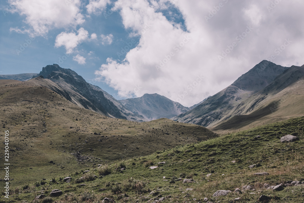 Closeup view mountains scenes in national park Dombai, Caucasus, Russia, Europe. Summer landscape, sunshine weather, dramatic blue sky and sunny day