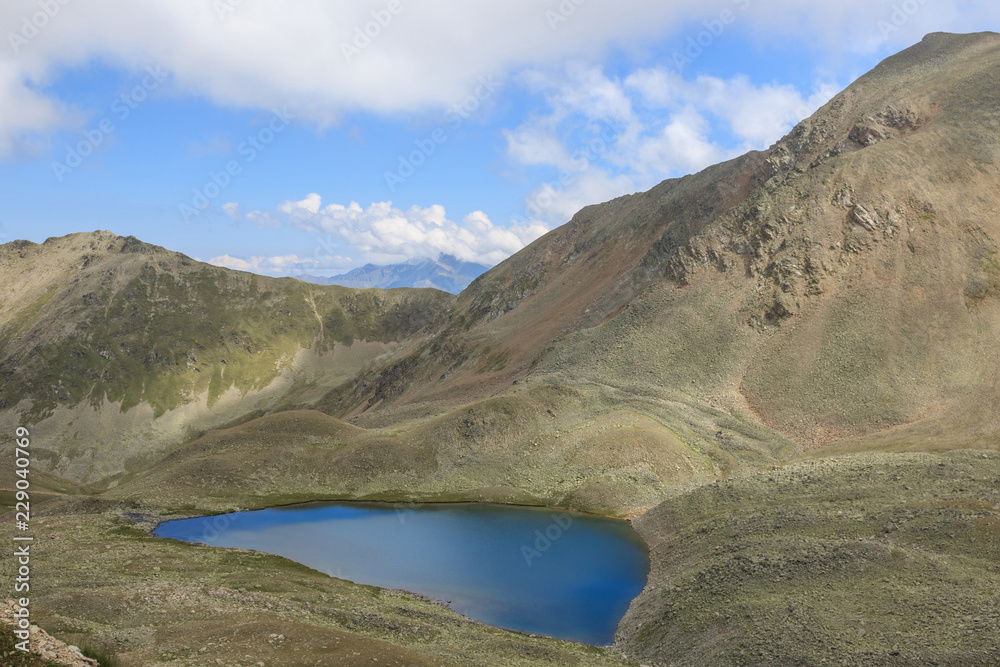 Lake scenes in mountains, national park Dombai, Caucasus, Russia, Europe. Summer landscape, sunshine weather, dramatic blue color sky and sunny day