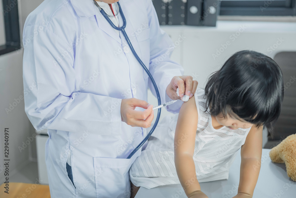 Asian doctor using a stethoscope to check his breathing and heart of a lovely girl, check the health of children,Thailand people Asian doctor using a stethoscope to check his breathing and heart of a lovely girl, check the health of children,Thailand people