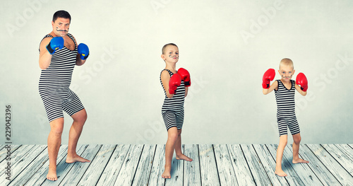Boxing . Father and two sons in vintage costumes play boxers.Boxing family. photo