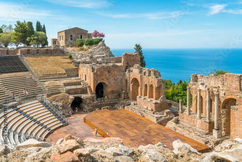 Ruins of the Ancient Greek Theater in Taormina on a sunny summer day with the mediterranean sea. Province of Messina, Sicily, southern Italy.