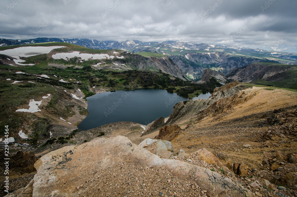 Beartooth Highway Pass in Montana on a summer day featuring an alpine lake and steep cliffs