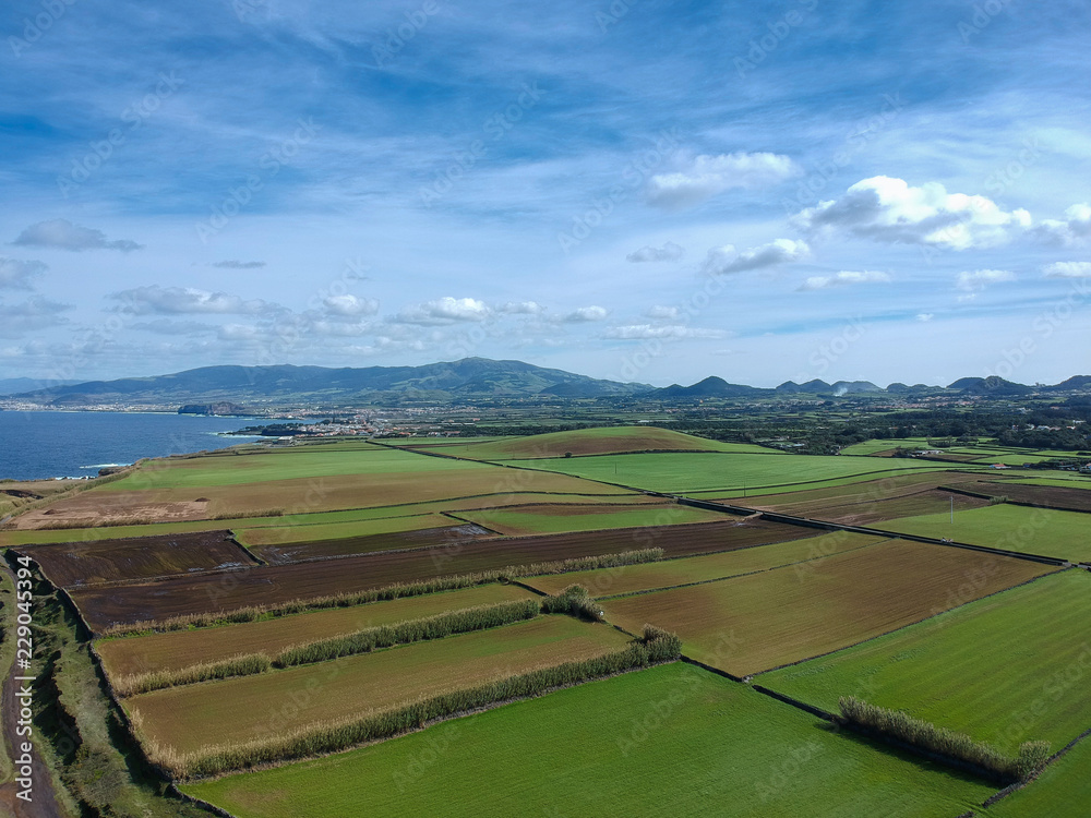 Aerial view green fields near from the coastline of island of São Miguel. Azores, Portugal. Drone Shot