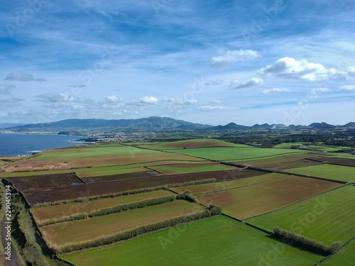 Aerial view green fields near from the coastline of island of São Miguel. Azores, Portugal. Drone Shot © nvphoto