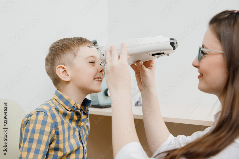 Child reception doctor ophthalmologist selects glasses of lens, check eye sight. Child reception doctor ophthalmologist selects glasses of lens, check eye sight.