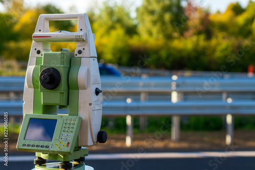 Surveyor equipment (theodolit or total positioning station) on the construction site of the motorway or road