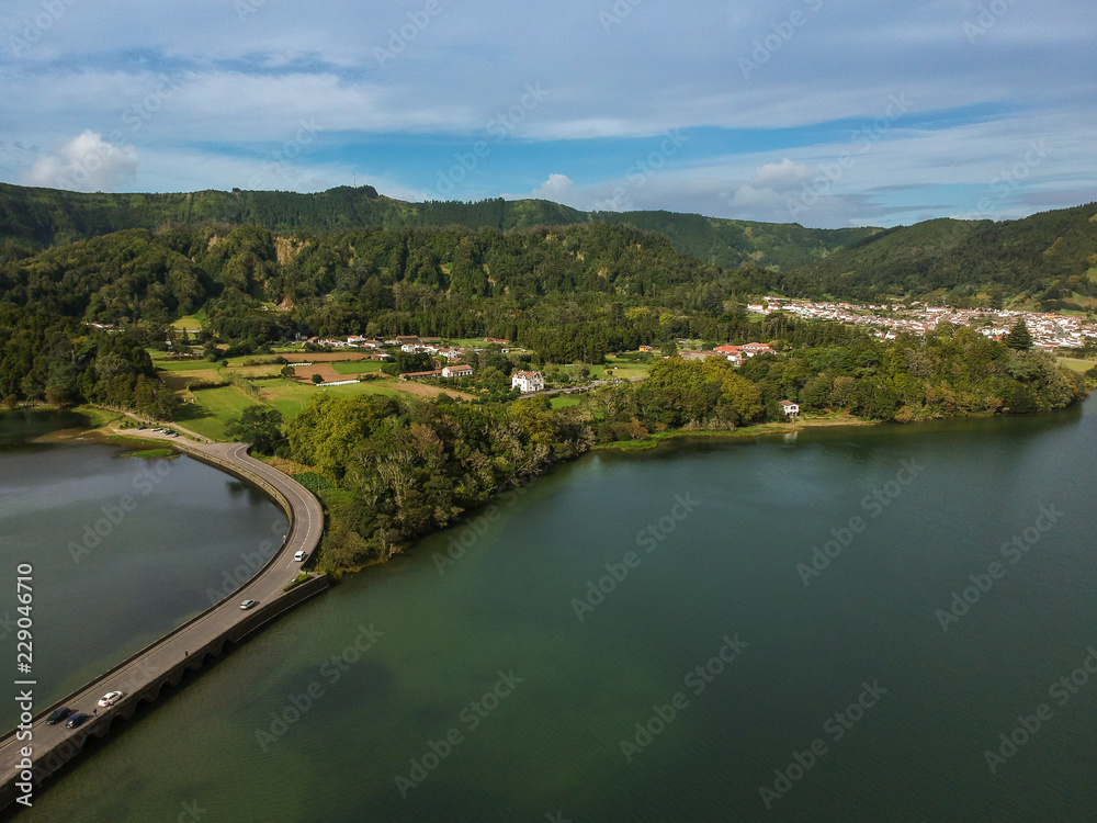 Obraz premium Aerial View from a beautiful lagoon surrounded by mountains. Ancient volcano crater. Seven Cities lagoon Azores Islands Portugal