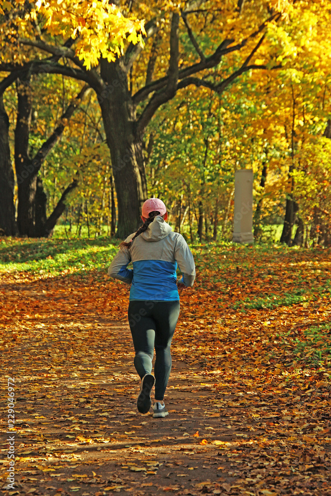 Fototapeta premium young girl jogging in the park