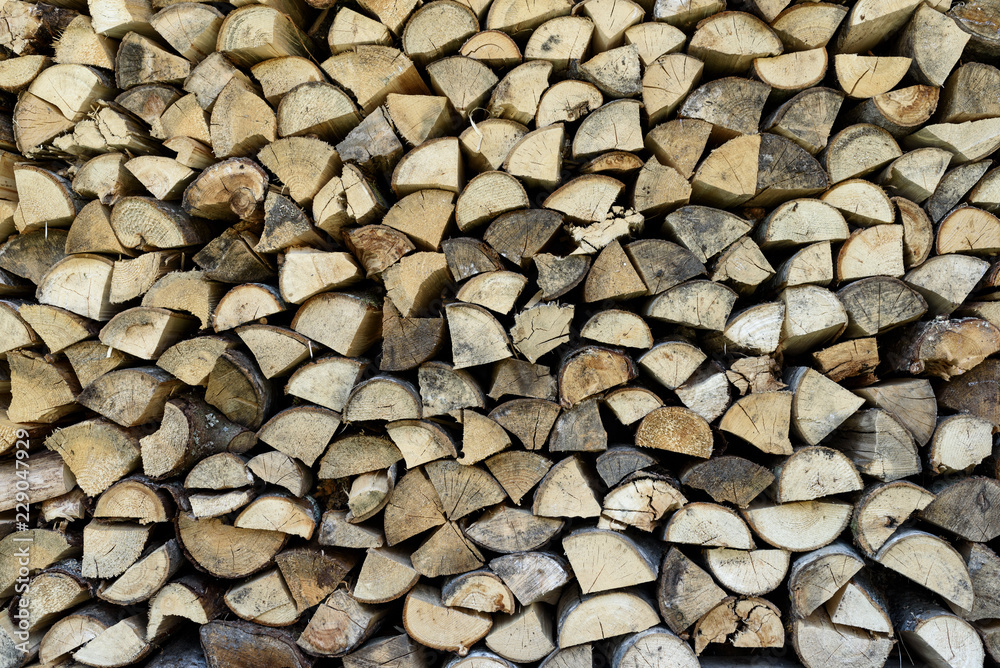 Wood pile wall from triangle cross section trees stumps. Wooden background. Wood pile wall from triangle cross section trees stumps. Wooden background.