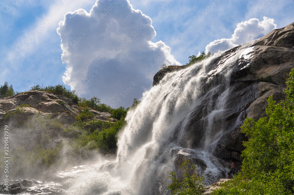 Waterfall scenes in mountains, national park Dombai, Caucasus, Russia, Europe. Sunshine weather and blue sky, summer day