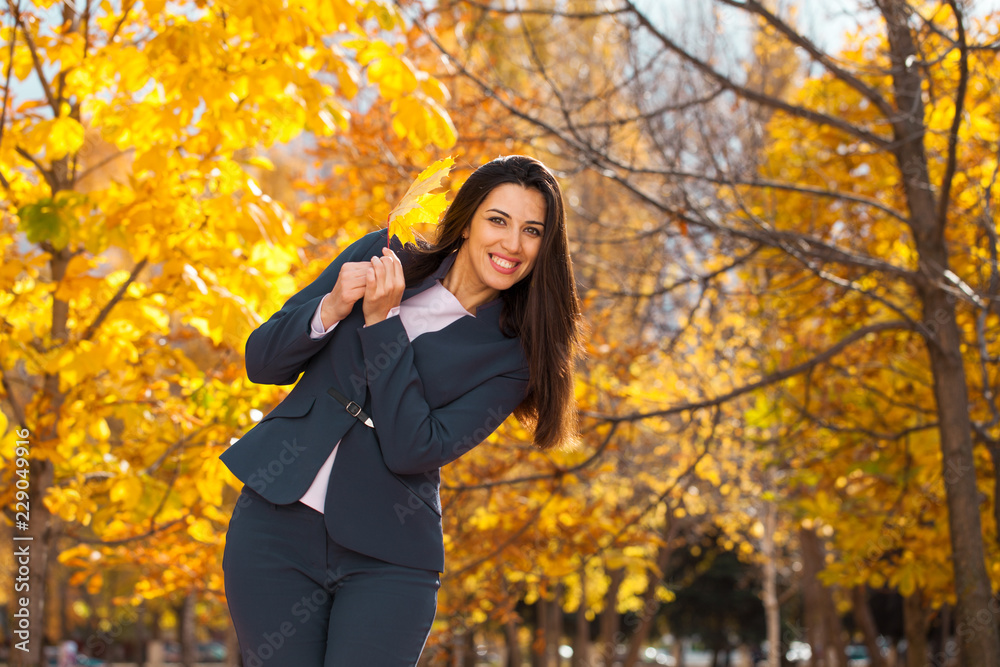 Happy arab businesswoman in blue suit walking in autumn park Happy arab businesswoman in blue suit walking in autumn park