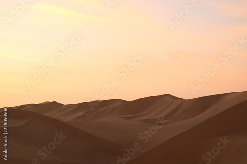 Pastel color of sunset sky over the sand dune of Huacachina desert in Ica Region, Peru, South America 
