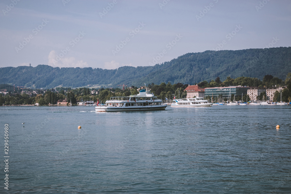 View on lake Zurich and mountains scenes, Zurich, Switzerland, Europe. Sunshine weather, dramatic moody blue color sky. Colorful summer day, evening time View on lake Zurich and mountains scenes, Zurich, Switzerland, Europe. Sunshine weather, dramatic moody blue color sky. Colorful summer day, evening time