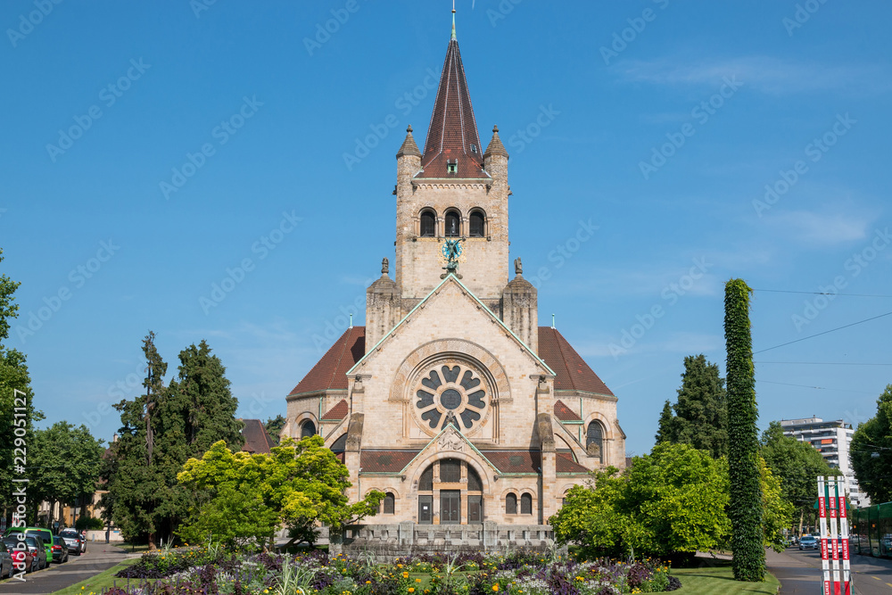Basel, Switzerland - June 20, 2017: View on St. Paul's Church (Pauluskirche), part of the Evangelical-Reformed Church of the Canton Basel. Summer day with blue sky