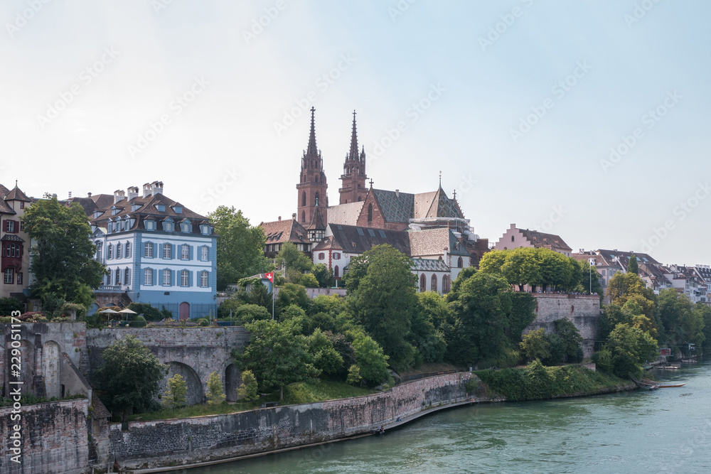 Basel, Switzerland - June 23, 2017: view on Basel city and river Rhine. Summer landscape, sunshine weather, blue sky and sunny day. People swim in river