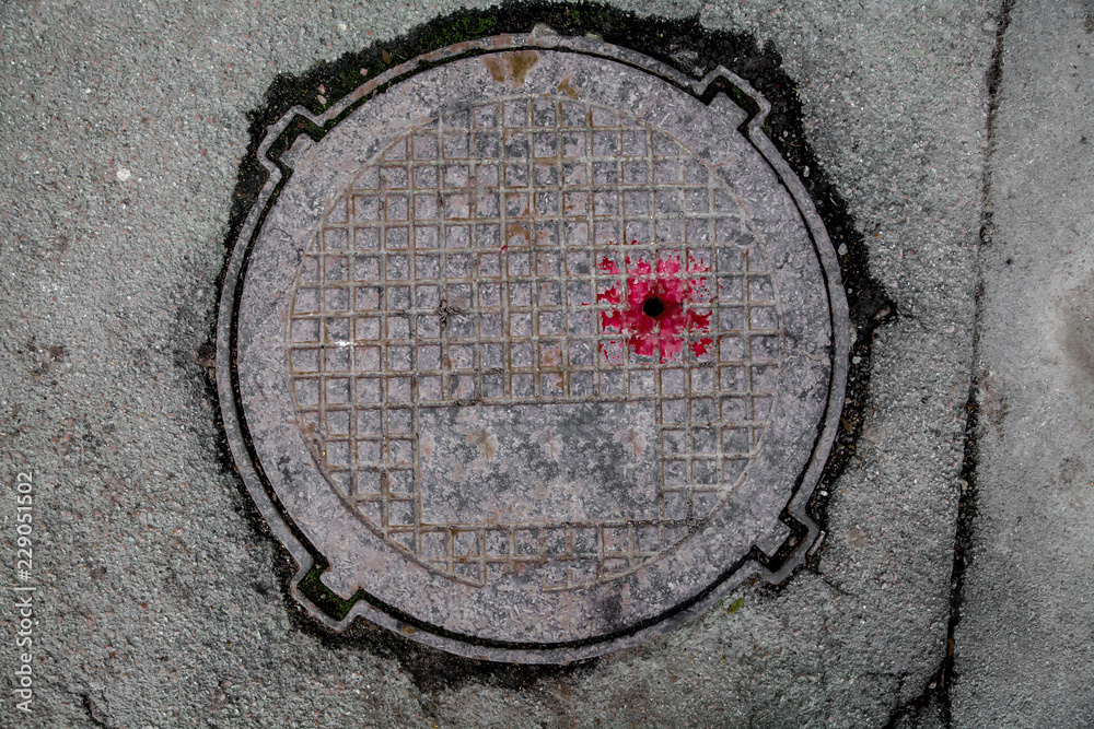 Manhole cover in the road of asphalt Manhole cover in the road of asphalt