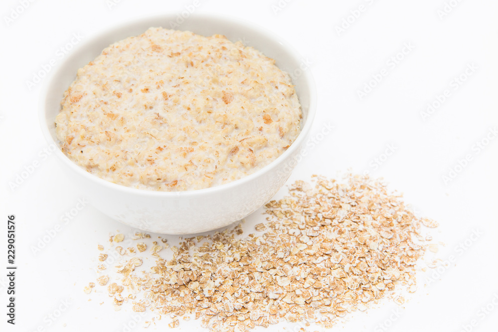 Oatmeal in white bowl on white background. Isolated on white. Healthy food Oatmeal in white bowl on white background. Isolated on white. Healthy food