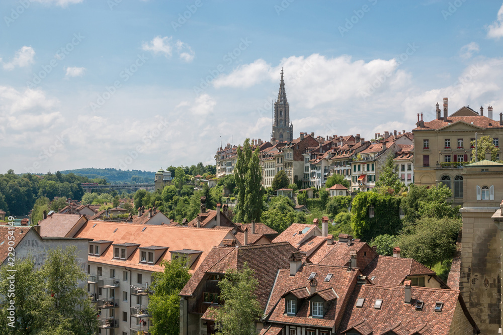 Panoramic view on Bern Minster and historic old town of Bern, capital of Switzerland, Europe. Summer landscape, sunny day and blue sky