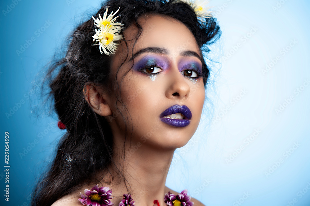 Middle Eastern Arabic beauty model with beautiful hair and dark blue lips  showcases her amazing lipstick