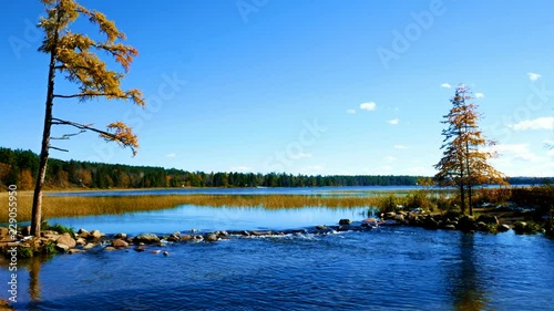 Lake Itasca held behind a man made dam at the headwaters of the Mississippi River at Lake Itasca State Park in Minnesota. Tourists walk on the rocks to say they have walked across the river.