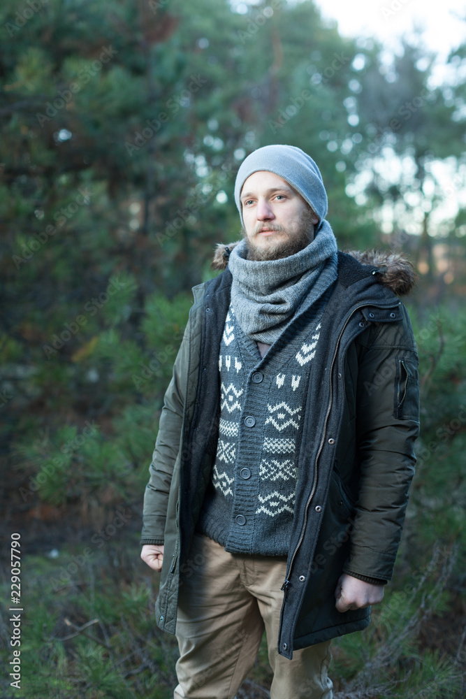 Portrait brutal bearded hipster man in the forest Portrait brutal bearded hipster man in the forest