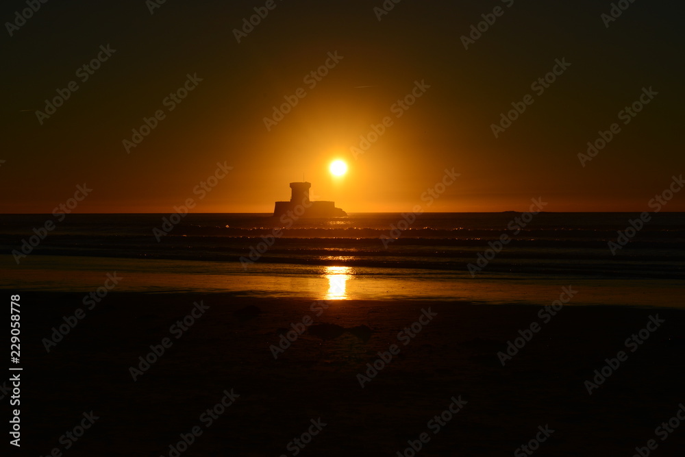 Naklejka premium St Ouen Bay, Jersey, U.K. Local 19th century landmark at sunset in Autumn.
