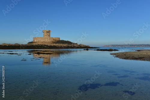 St Ouen Bay, Jersey, U.K. Uninhabited 19th century military tower on a calm Autumn morning.
