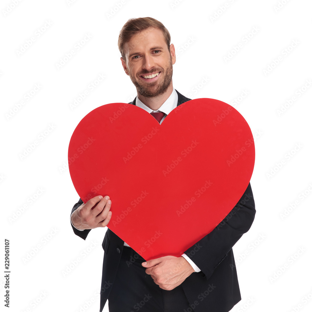 portrait of romantic businessman smiling and holding valentine's day heart portrait of romantic businessman smiling and holding valentine's day heart