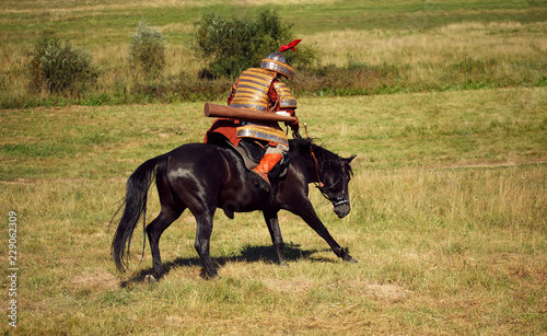 Medieval armored rider on horse. Equestrian soldier in historical costume