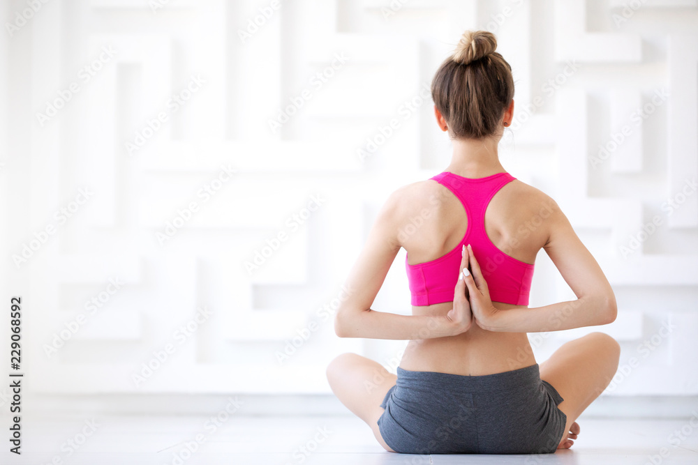 Fototapeta premium Young sporty attractive woman practicing yoga, vajrasana pose.