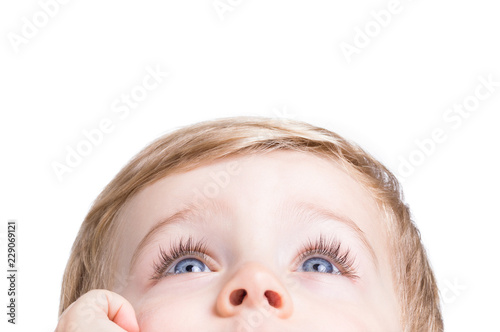 Adorable little boy looking up on a white background