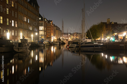 Cozy christianshavn channel in the danish capital of Copenhagen. This is the harbor for many liveaboard and boats made for housing