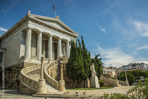 amazing architecture concept of ancient Greece old marble palace facade with columns statue and front yard, contrast blue sky background 