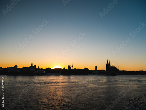 Cityscape of Cologne, Germany, at sunset.