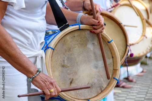 Womans percussionists playing drums during folk samba performance on Belo Horizonte, Minas Gerais