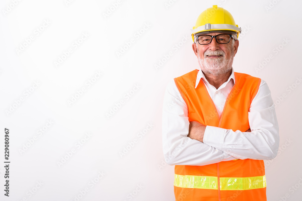 Studio shot of happy senior bearded man construction worker smil Studio shot of happy senior bearded man construction worker smil