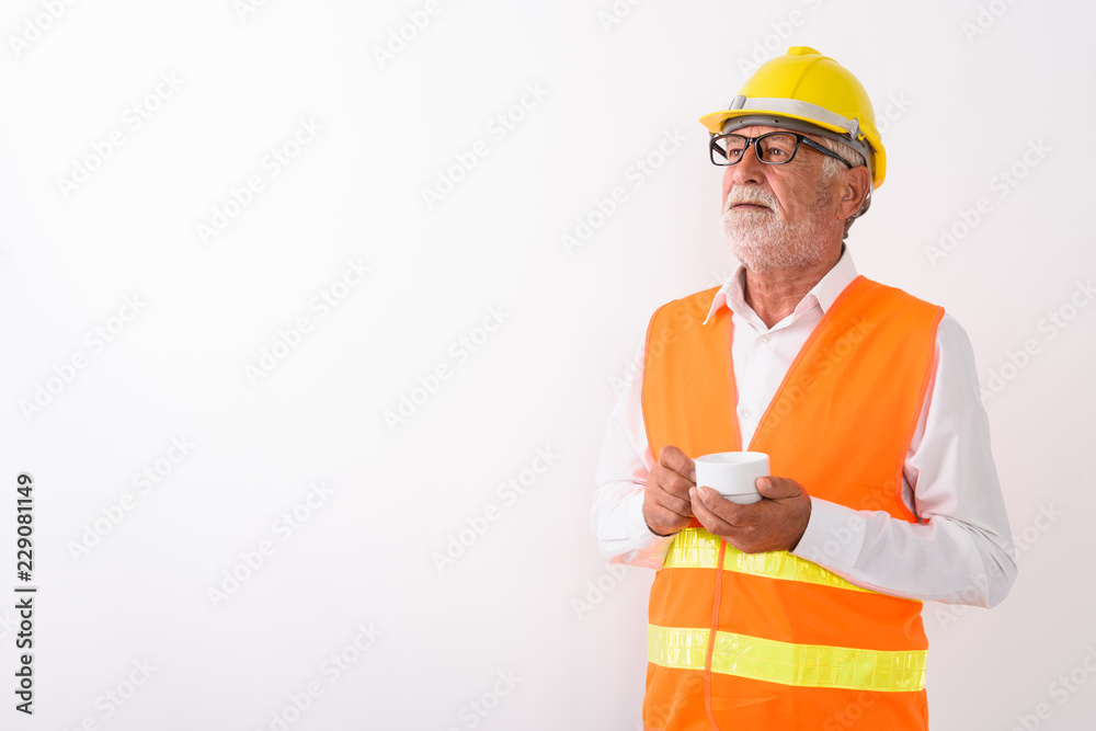 Studio shot of handsome senior bearded man construction worker t Studio shot of handsome senior bearded man construction worker t