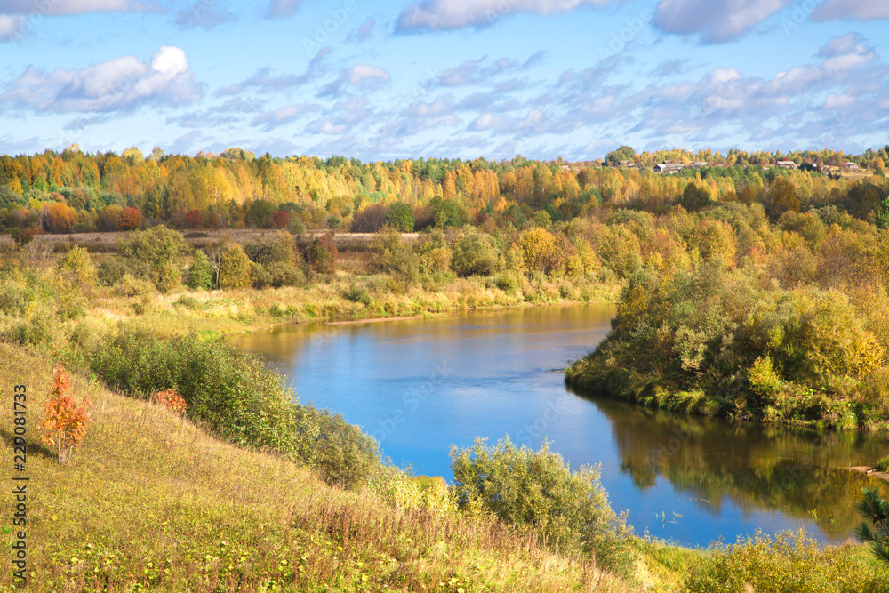 Beautiful autumn landscape with a river in a rural area