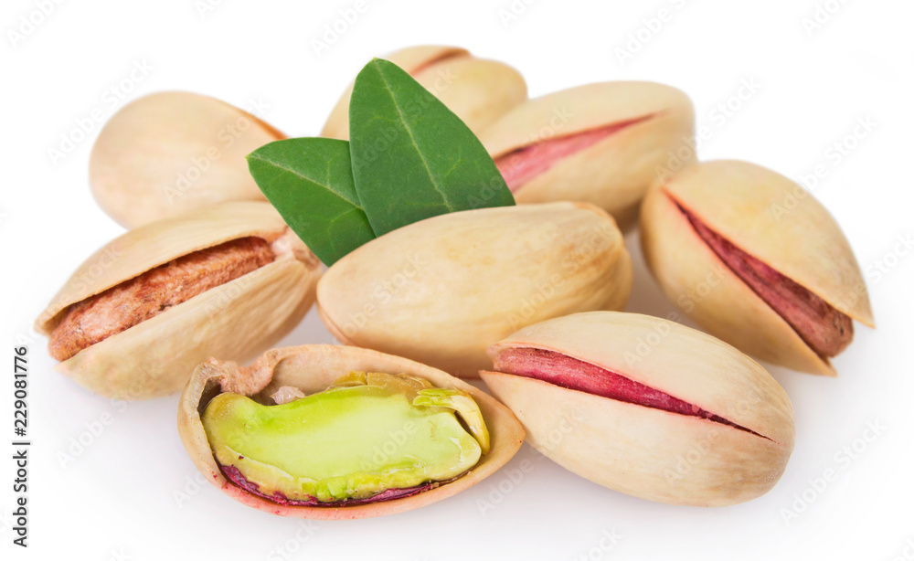 Pistachios with leaves on white background Pistachios with leaves on white background
