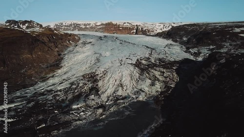 Iceland landscape of glacier Solheimajokull glacier. Beautiful nature aerial drone video of Icelandic nature. Tourist destination and attraction on South Iceland. Glacial lake / lagoon.
