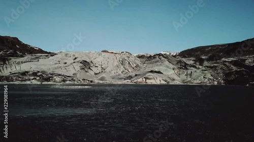 Iceland landscape of glacier Solheimajokull glacier. Beautiful nature aerial drone video of Icelandic nature. Tourist destination and attraction on South Iceland. Glacial lake / lagoon.
