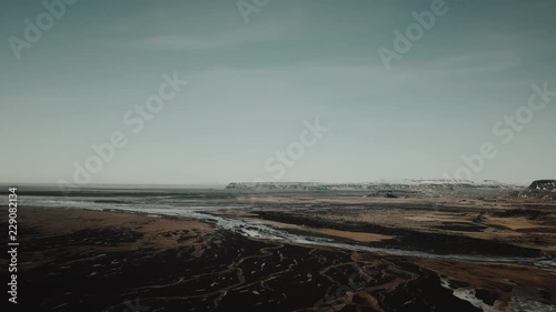 Aerial view of a magnificent mountain rock with side sunlight during sunset time in Iceland. 4K