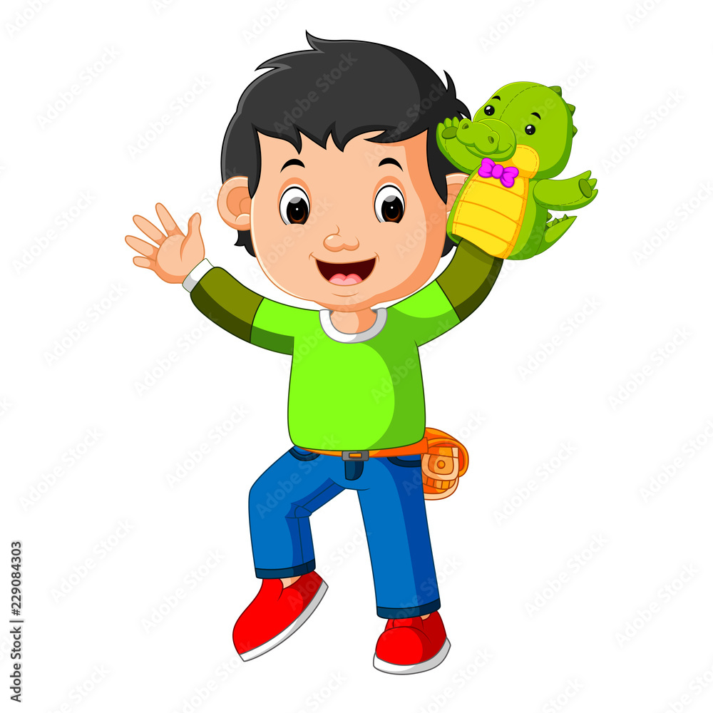 the happy boy was using crocodile puppet 