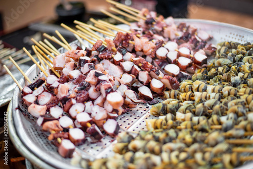Photography Squid skewers shop at the street food in Seoul.
